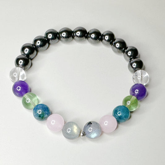 Multicolored beaded bracelet on a light gray background