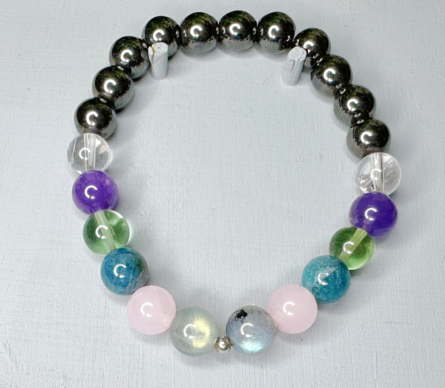 Bracelet with multicolored beads on a light gray background
