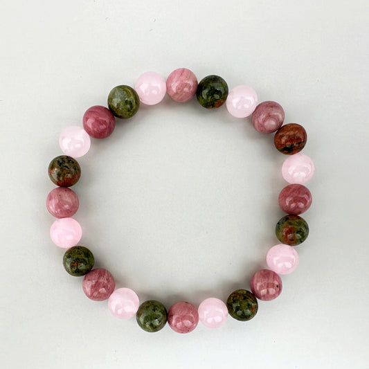 Beaded bracelet with pink and green beads on a white background