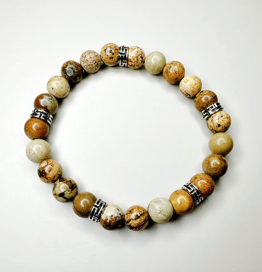 Beaded bracelet with natural stone beads and metal accents on a white background