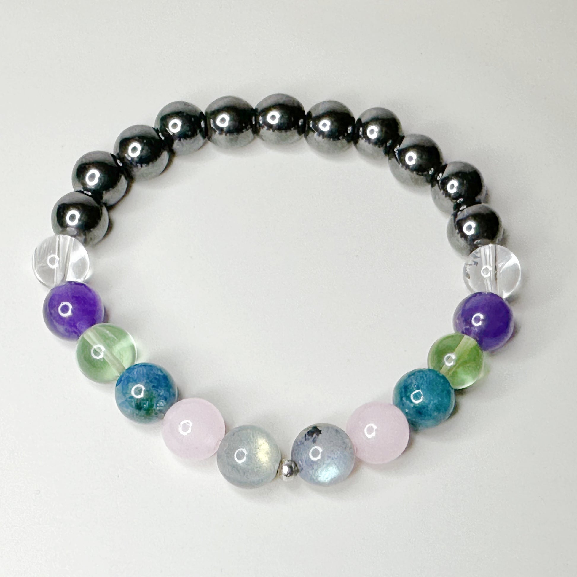 Multicolored beaded bracelet on a light gray background