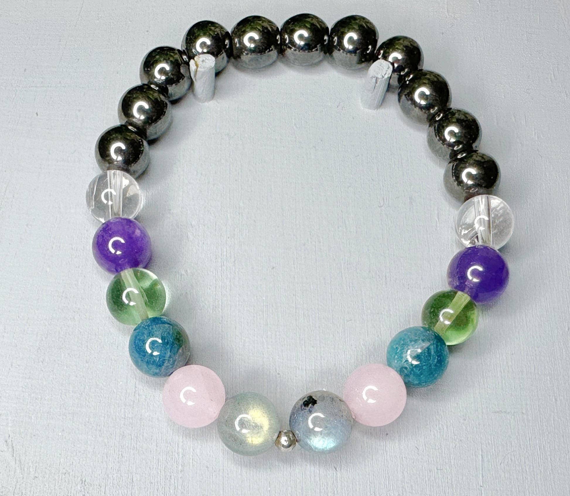 Bracelet with multicolored beads on a light gray background