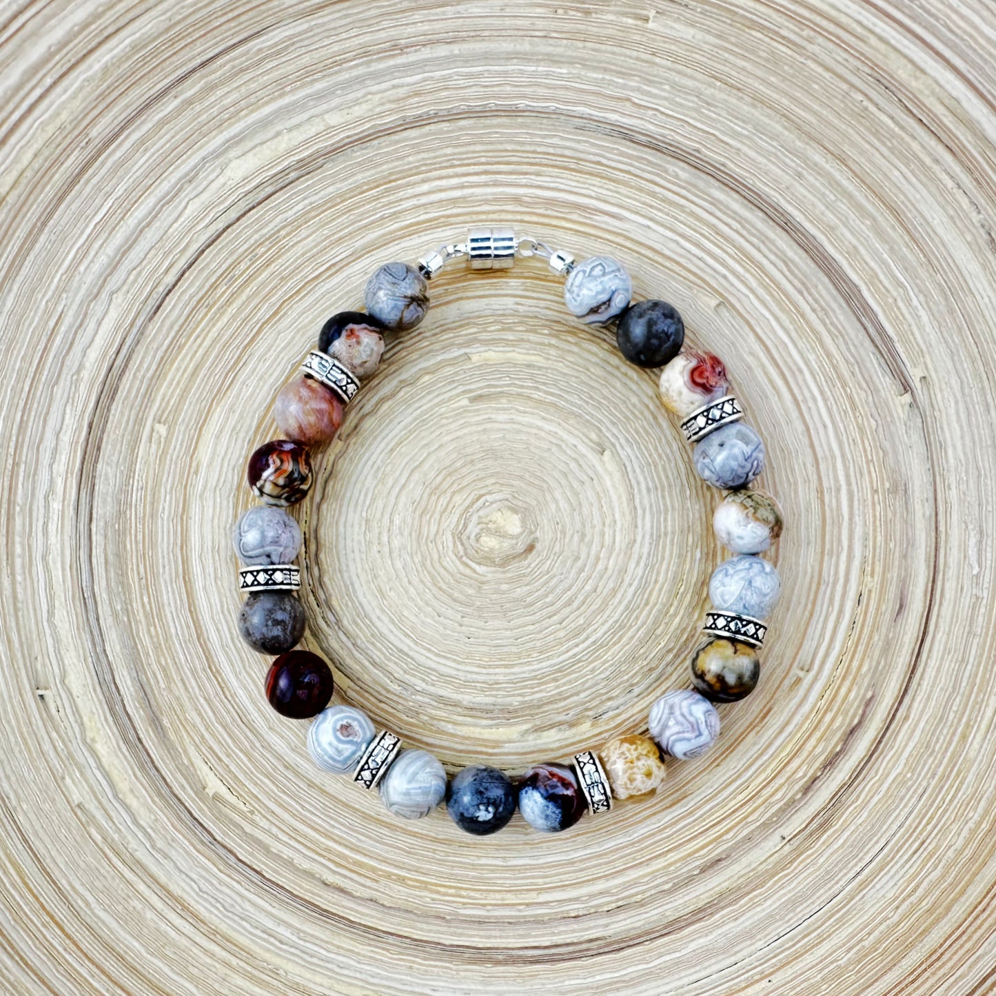 Beaded bracelet with various stones on a woven surface