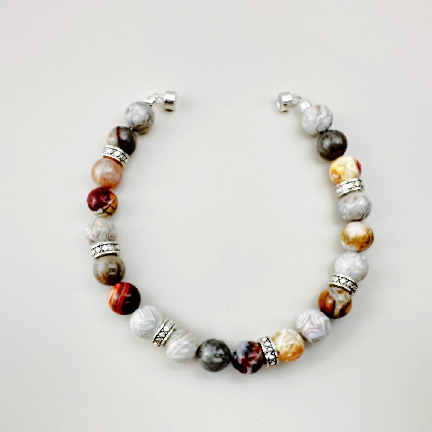 Beaded bracelet with multicolored beads on a light gray background
