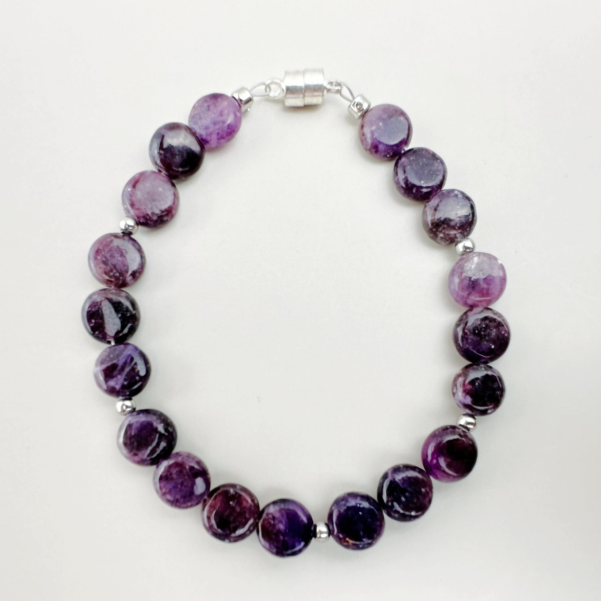 Purple beaded bracelet on a white background