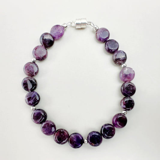 Purple beaded bracelet on a white background