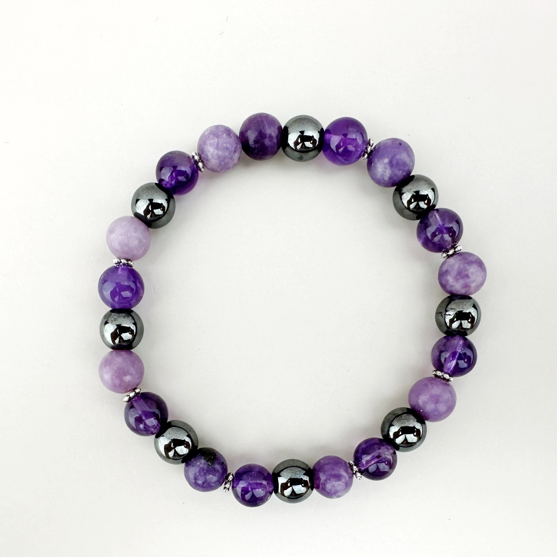 Purple and black beaded bracelet on a white background
