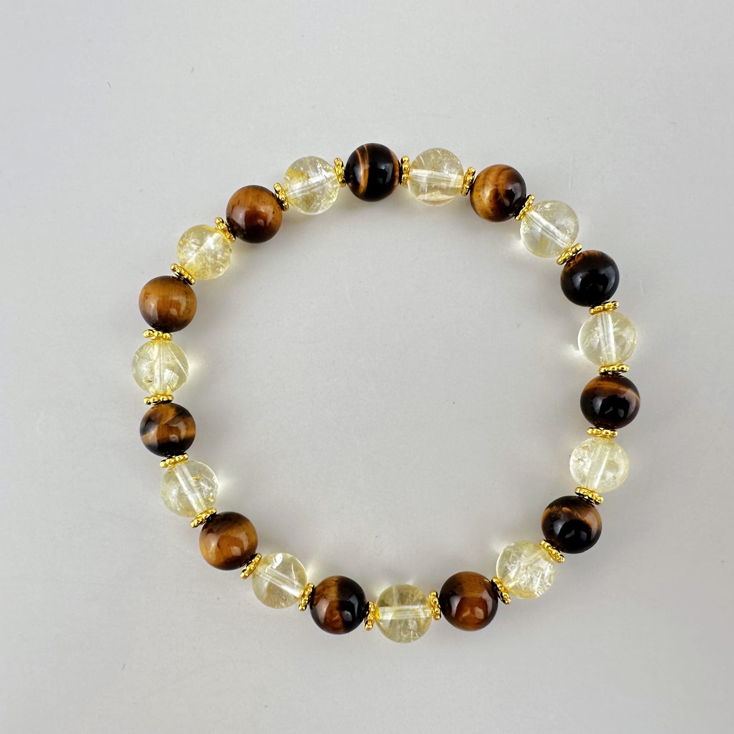 Bracelet with brown, clear, and black beaded design on a light gray background