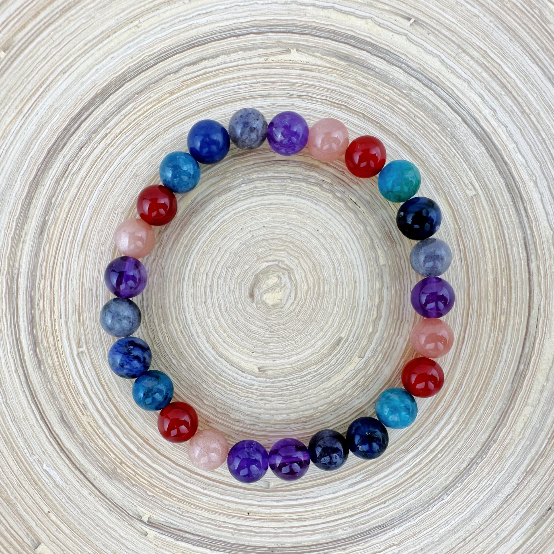 Multicolored beaded bracelet on a textured beige background