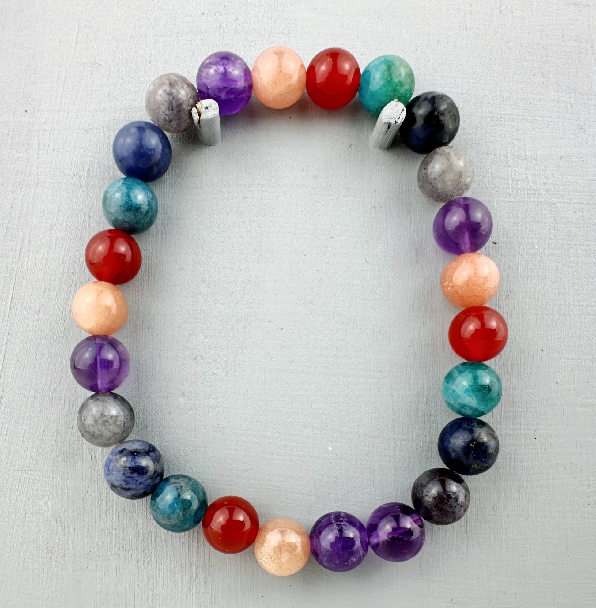 Multicolored beaded bracelet on a light gray background