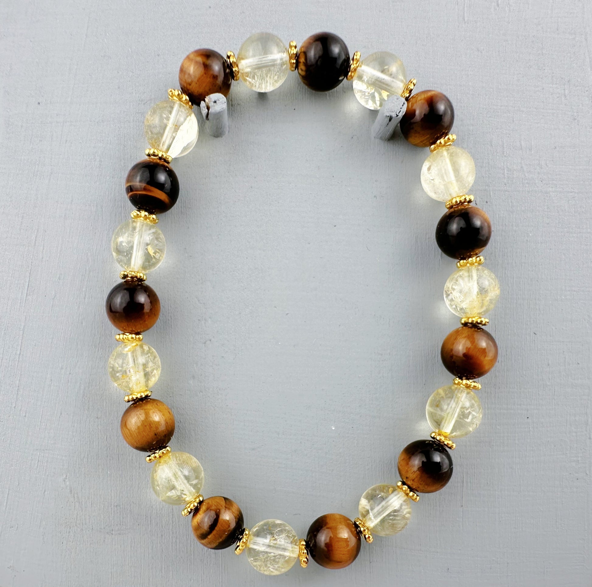 Beaded bracelet with brown, clear, and black beads on a gray background